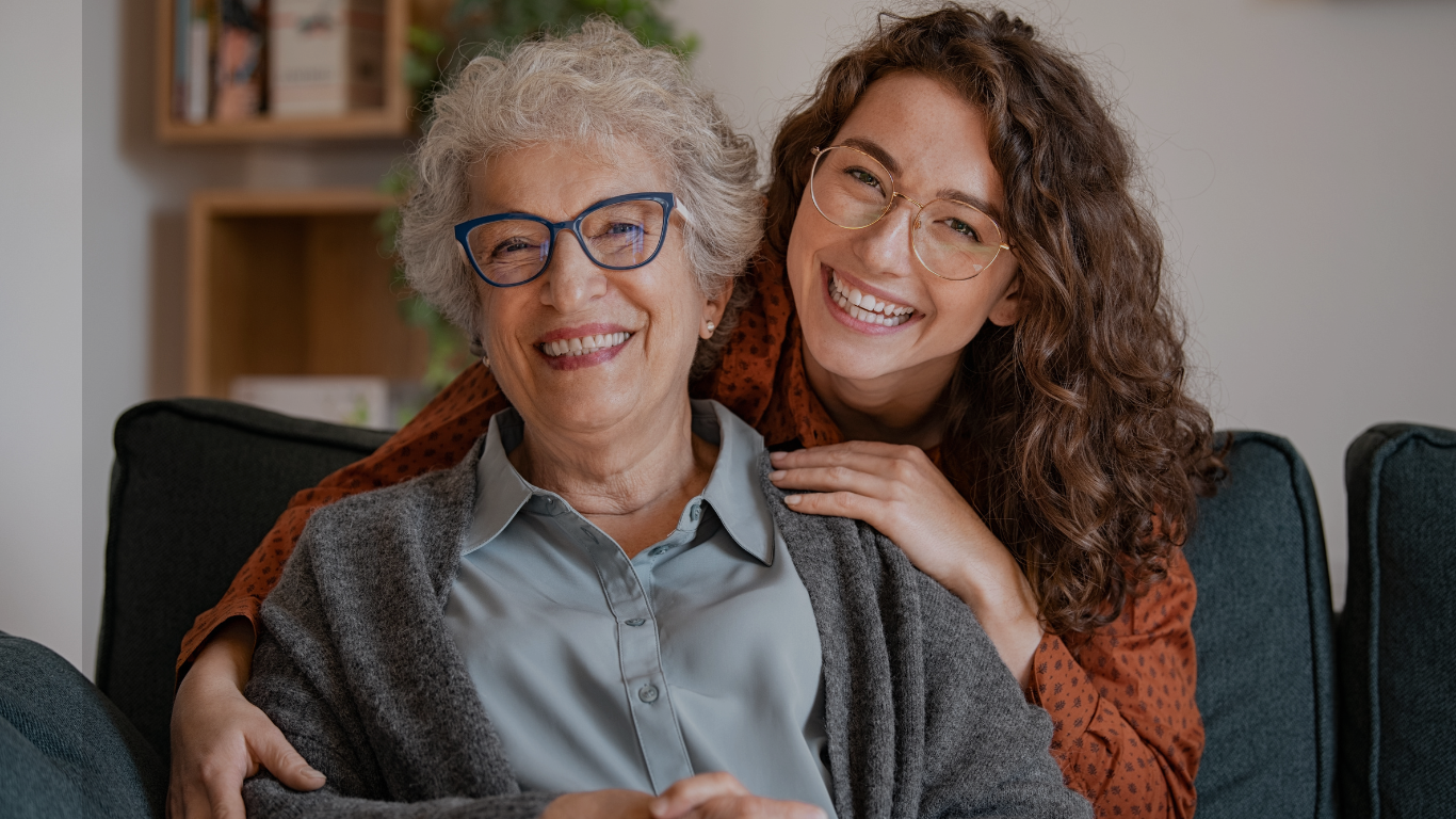 A grandma is pictured smiling with her granddaughter at home