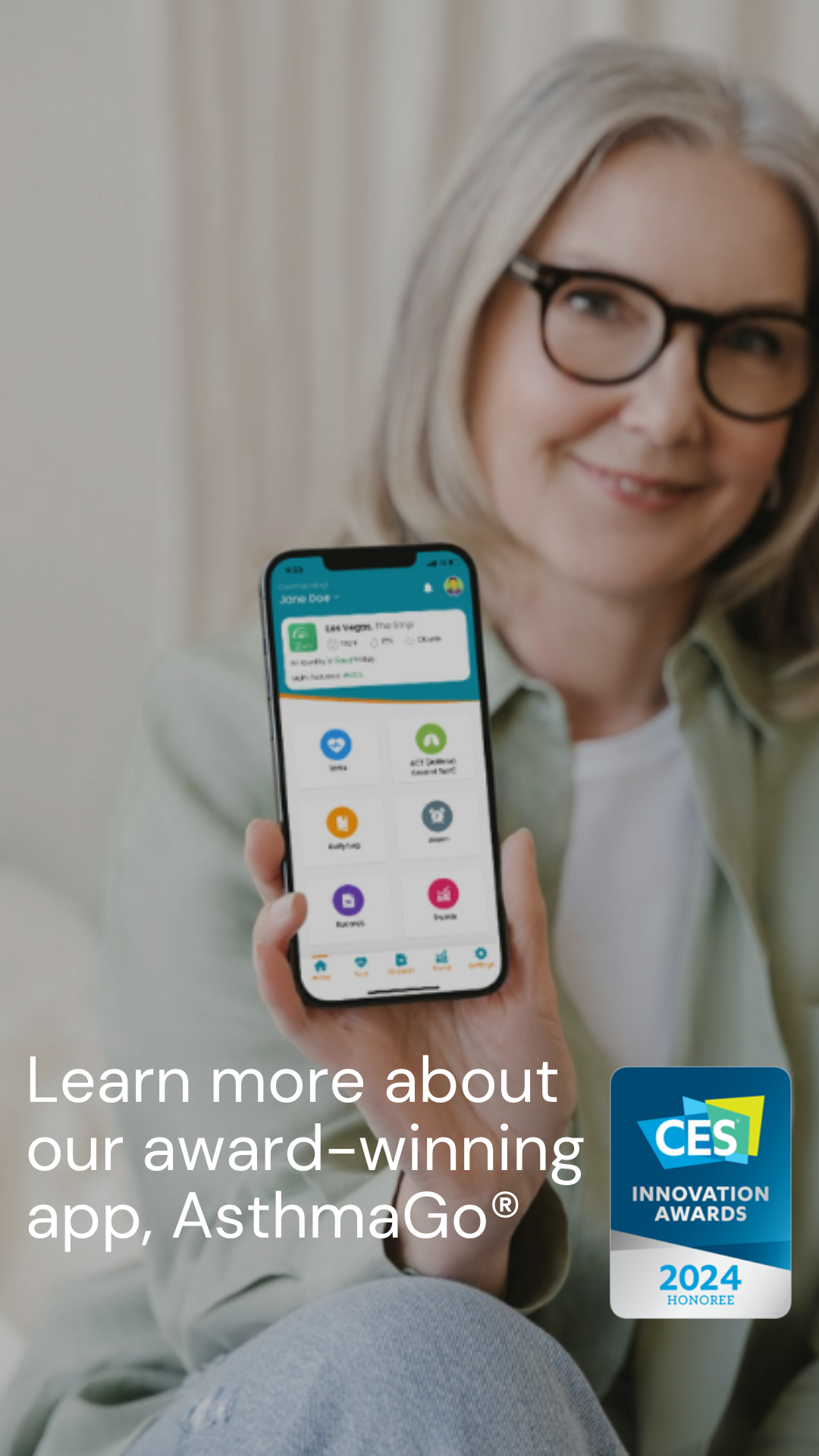 A woman holds her phone out, proudly displaying CMI Health's AsthmaGo app.