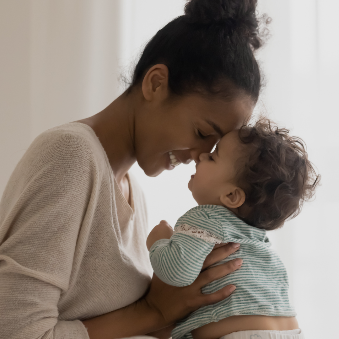 A mom is pictured cuddling with her baby