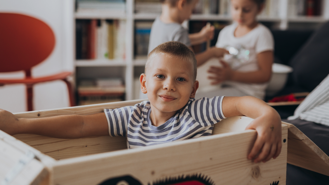 A child looks happy as he plays with his siblings at home